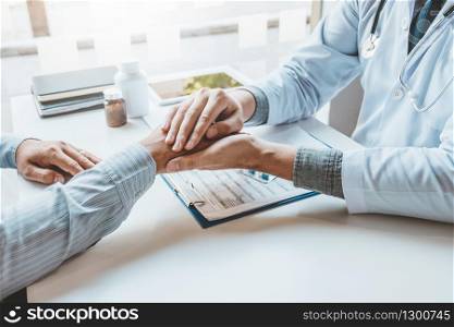 Doctor holding hands for comforting and care patient hospital and medicine concept