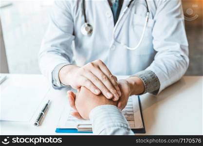 Doctor holding hands for comforting and care patient hospital and medicine concept