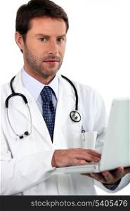 doctor holding laptop