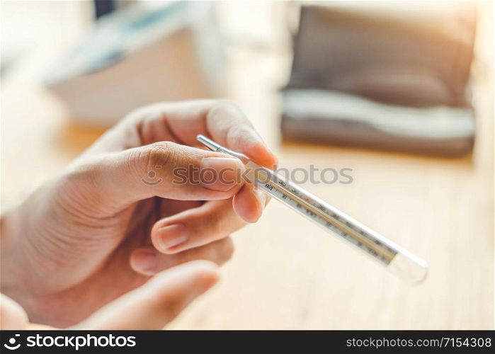 Doctor holding on thermometer for checking sick patient Health care hospital and medicine concept