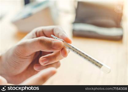 Doctor holding on thermometer for checking sick patient Health care hospital and medicine concept