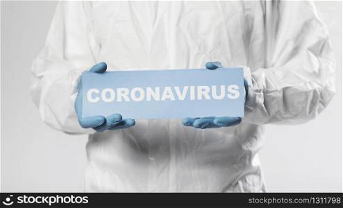 doctor holding paper with coronavirus lettering