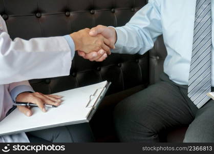 Doctor holding patient&rsquo;s hand, and reassuring his male patient helping hand concept.