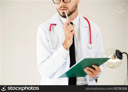 Doctor holding patients health file at office table in the hospital. Medical and healthcare concept.