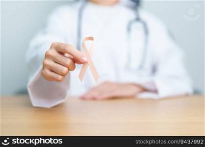 Doctor holding Peach Ribbon for September Uterine Cancer Awareness month. Uterus and Ovaries, Endometriosis, Hysterectomy, Uterine fibroids, Reproductive, Healthcare and World cancer day concept