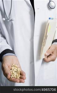 Doctor holding pills and a document