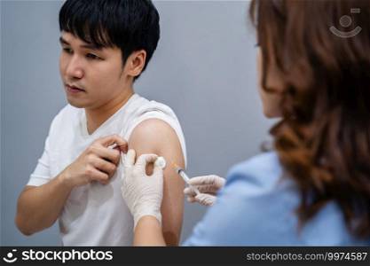 doctor holding syringe and using a cotton before make injection to patient. Covid-19 or coronavirus vaccine