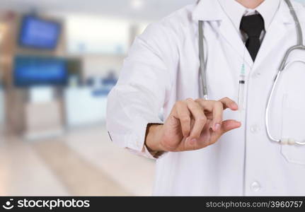 doctor holding syringe in hospital background