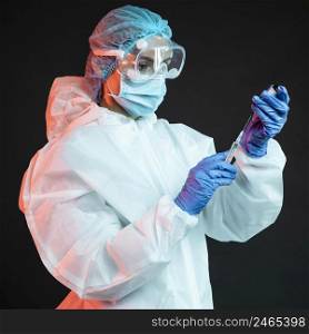doctor holding syringe while wearing medical mask