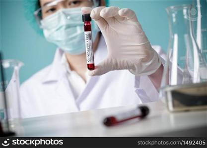 Doctor holding testing patients blood samples for Coronavirus Outbreak (COVID-19) in the laboratory, New coronavirus 2019-nCoV from Wuhan China concept