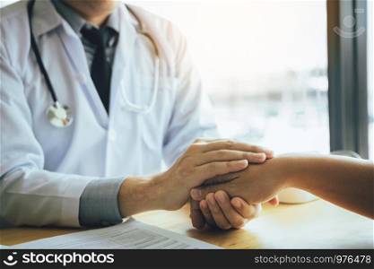 Doctor holds hands and leaves comforting counselors to patient.
