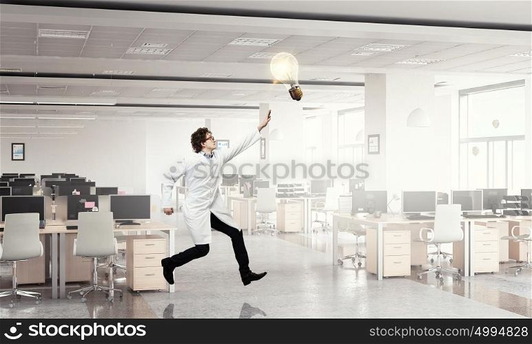 Doctor in a hurry. Funny image of young running doctor in white uniform