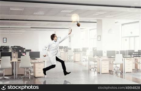 Doctor in a hurry. Funny image of young running doctor in white uniform