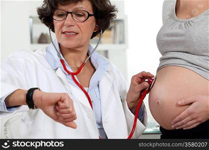Doctor in appointment with pregnant woman