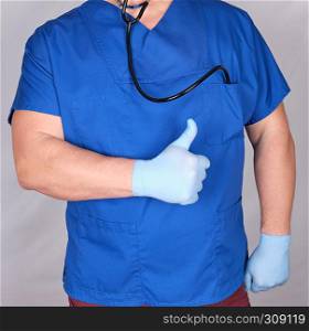 doctor in blue uniform shows a gesture of approval, like. Gray background