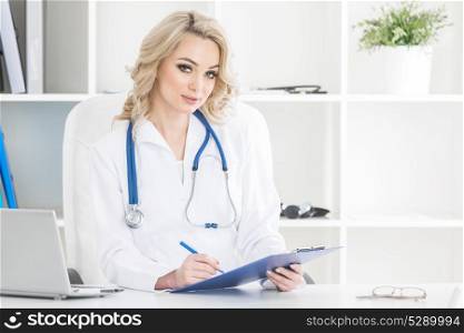 Doctor in clinical office. Portrait of smiling beautiful female doctor in a clinical office