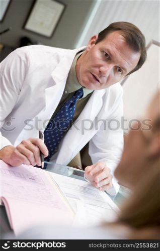 Doctor in consultation with woman at IVF clinic (selective focus)