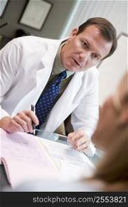 Doctor in consultation with woman at IVF clinic (selective focus)