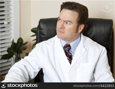 Doctor in his office, worried about a patient.