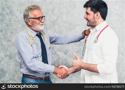 Doctor in hospital handshake with another doctor. Healthcare people teamwork and medical staff service concept.