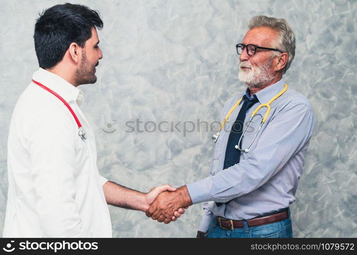 Doctor in hospital handshake with another doctor. Healthcare people teamwork and medical staff service concept.