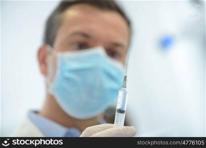 doctor in medical mask ready to make injection