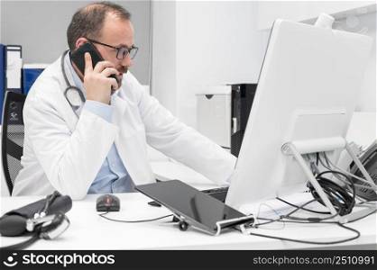 Doctor in office talking on phone. High quality photography.. Doctor in office talking on phone