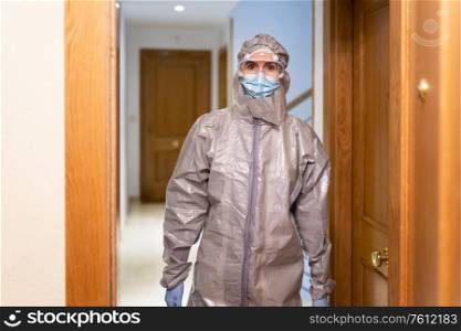 Doctor in PPE Personal Protective Equipment coming into the house to see a patient. Doctor in PPE Personal Protective Equipment coming into the house