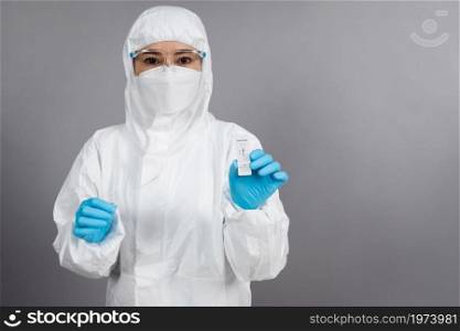 doctor in PPE suit holding Coronavirus(Covid-19) negative test result with Antigen Rapid Test kit (ATK)