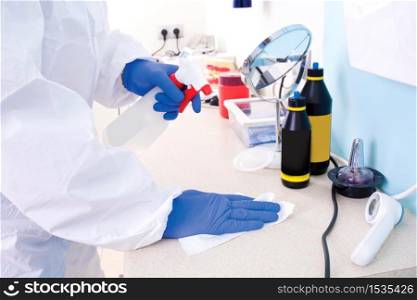 Doctor in protective suit uniform cleans the laboratory. Coronavirus outbreak. Covid-19 concept.