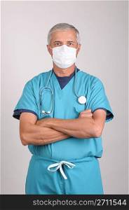 Doctor in Scrubs with Mask and Arms Folded