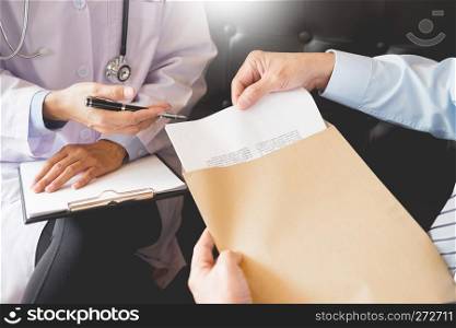 Doctor informing patient's of diagnosis medical record from paper in hospital.
