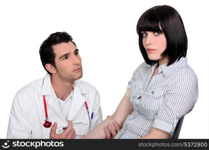 Doctor kneeling by a patient