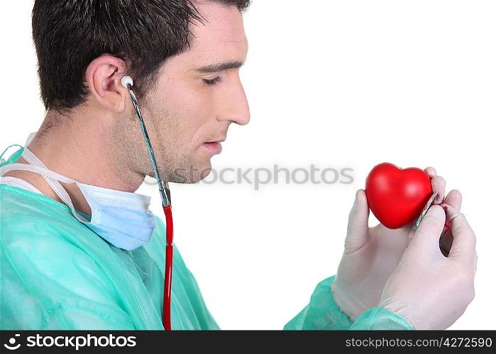 doctor listening a red toy hearth