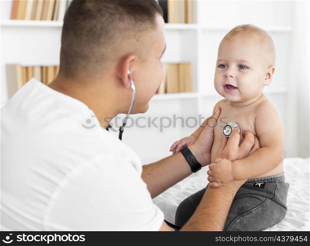 doctor listening little baby with stethoscope