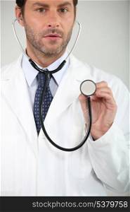 Doctor listening through stethoscope