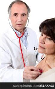 Doctor listening to a woman&rsquo;s chest