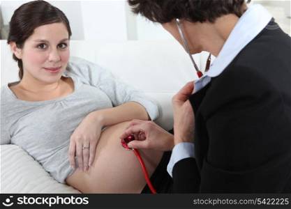 Doctor listening to an unborn baby&rsquo;s heartbeat