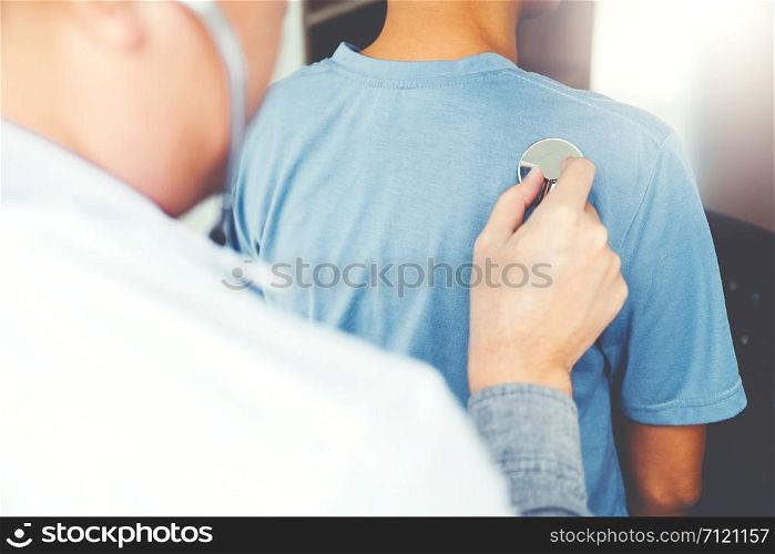 Doctor listening to patients breathing sound with Stethoscope
