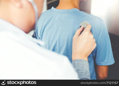 Doctor listening to patients breathing sound with Stethoscope