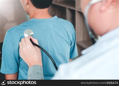 Doctor listening to patients breathing sound with Stethoscope