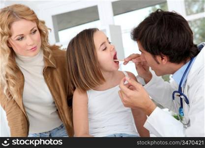 Doctor looking at sick little girl throat