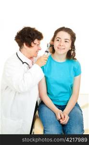 Doctor looking in a teenage patient&rsquo;s ears with an otoscope. Isolated on white.