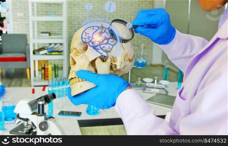doctor looking  skull model by magnifying glass with futuristic technology health icon , health care concept
