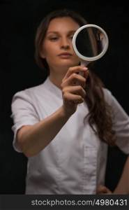 Doctor Looking Through Magnifying Glass