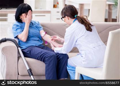 Doctor making injection to senior old woman