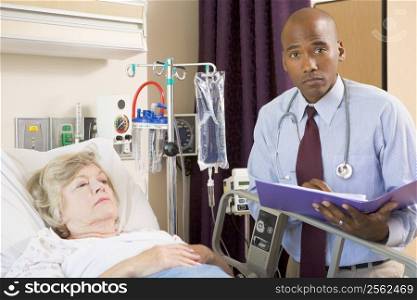 Doctor Making Notes About Patient,Looking Serious