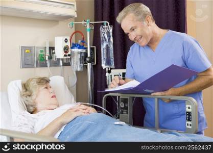 Doctor Making Notes About Senior Woman Patient