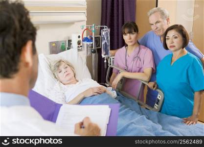 Doctor Making Notes On Patient