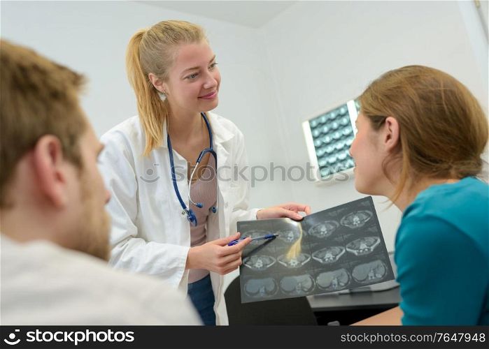 doctor man and woman talking and examining spine mri results
